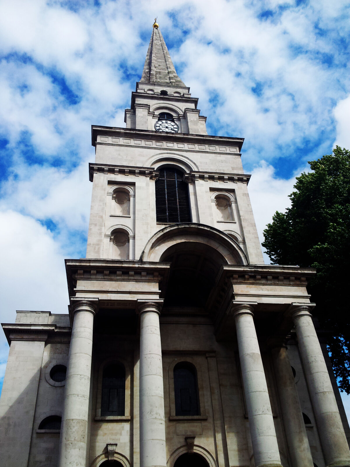 A white church with a tall steeple.